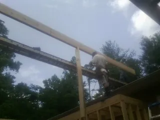 Carpenter setting a ridge beam over a new addition frame — Ice Dam Removal by Roofing Brothers in Storrs Mansfield