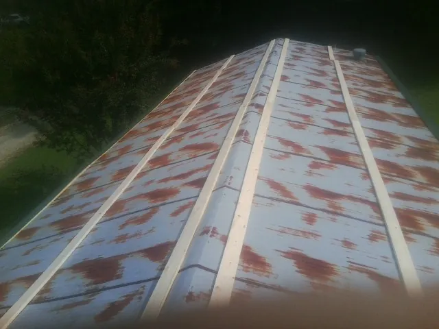 Rusted metal roof panels with new wood purlins before replacement — Storm Damage Roof Repair in Storrs Mansfield by Roofing Brothers